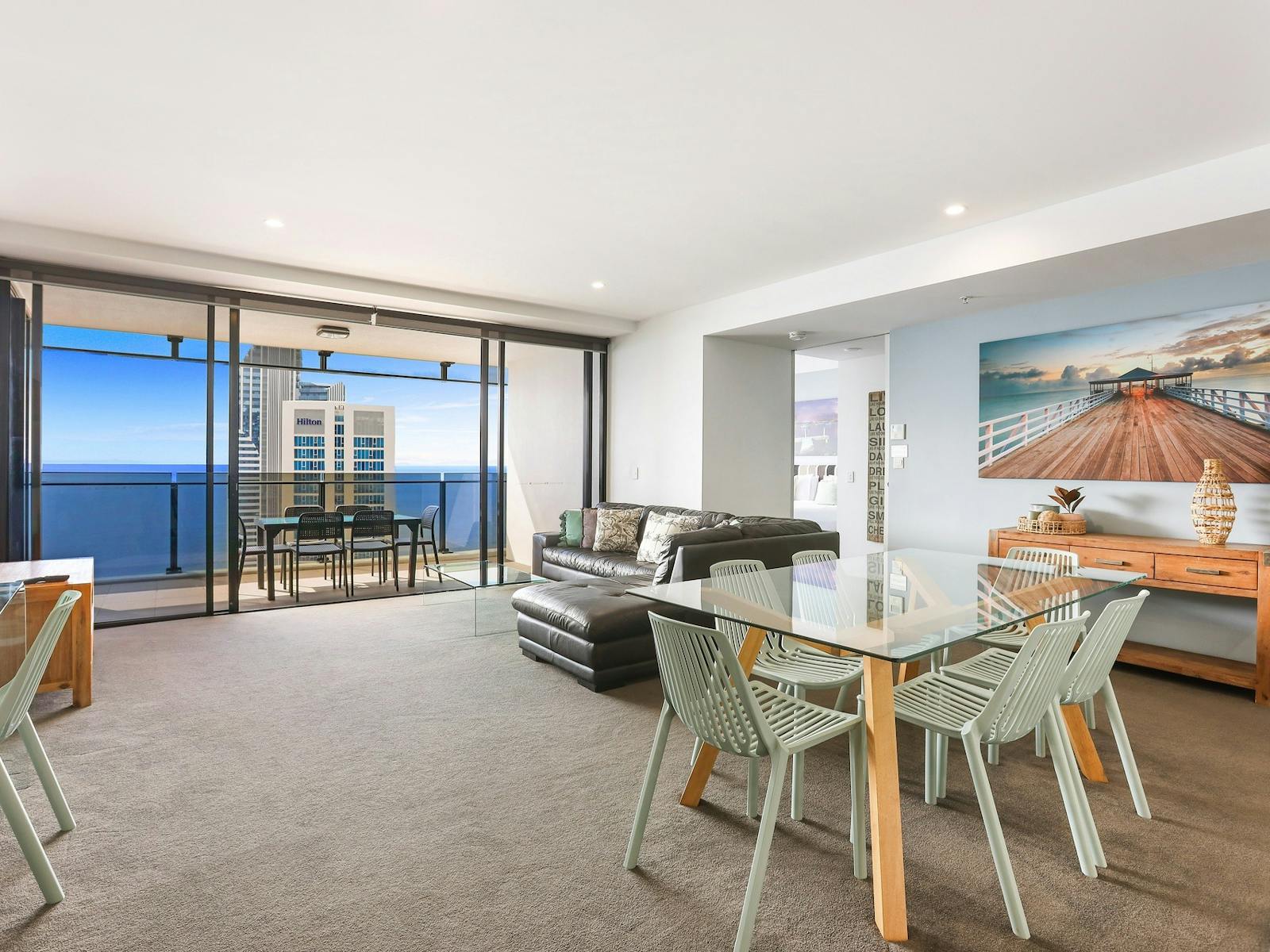 Circle on Cavill Surfers Paradise - lounge room and dining table with balcony ocean views Circle on Cavill Surfers Paradise - lounge room and dining table with balcony ocean views