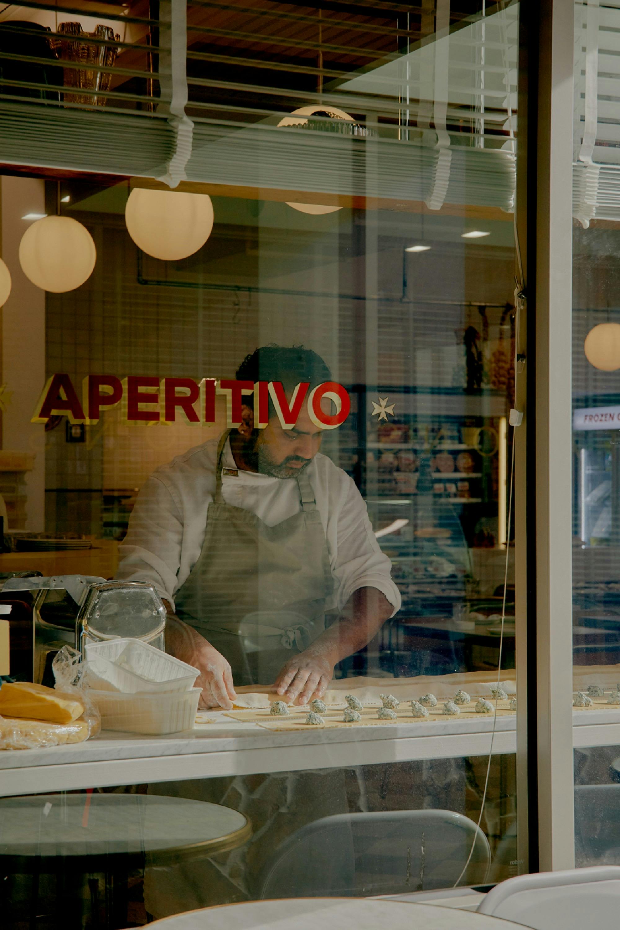 outside shot of the pasta bar with someone rolling pasta sheets