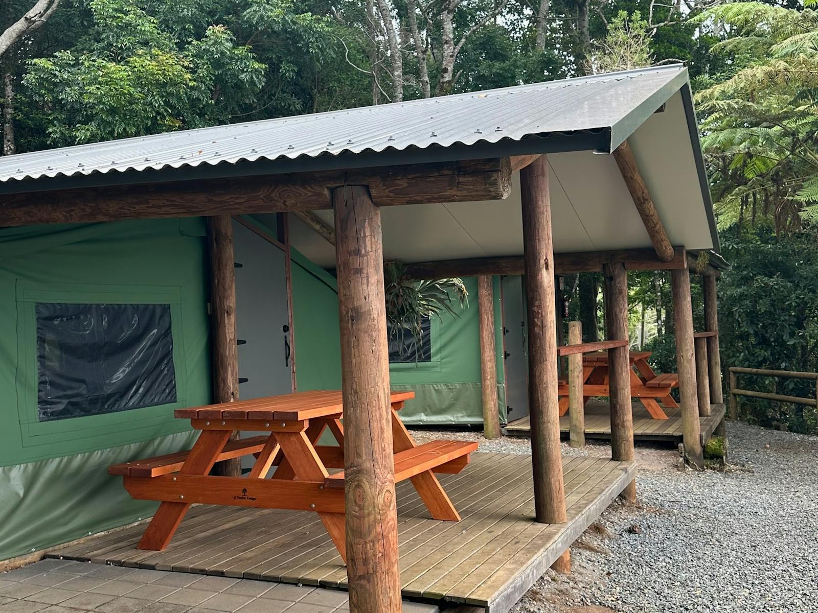 Image shows the exterior courtyard and fire pit of the Safari Tents Image shows the exterior courtyard and fire pit of the Safari Tents