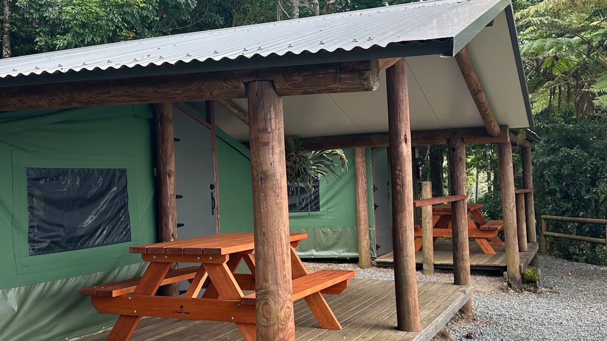 Image shows the exterior courtyard and fire pit of the Safari Tents