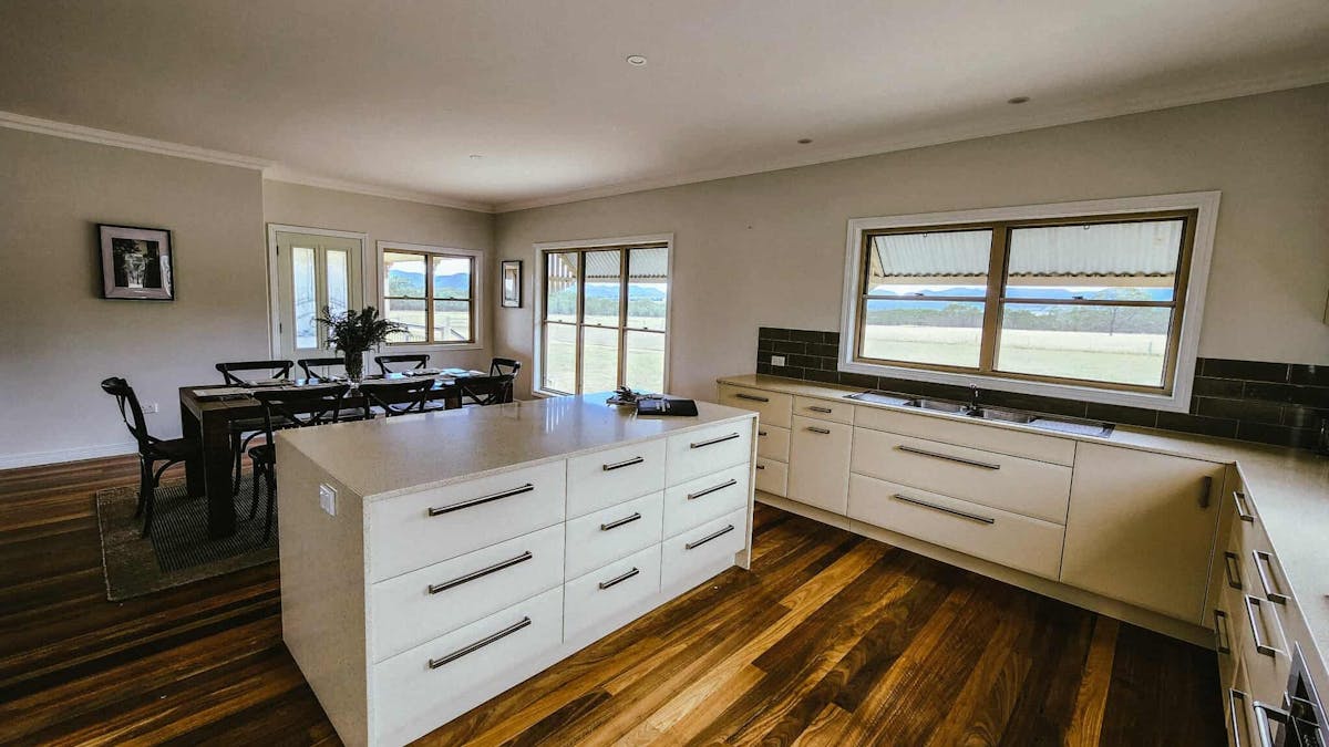 Modern kitchen with walk in pantry and dishwasher and 8-seater dining with bar stoolequipped kitchen
