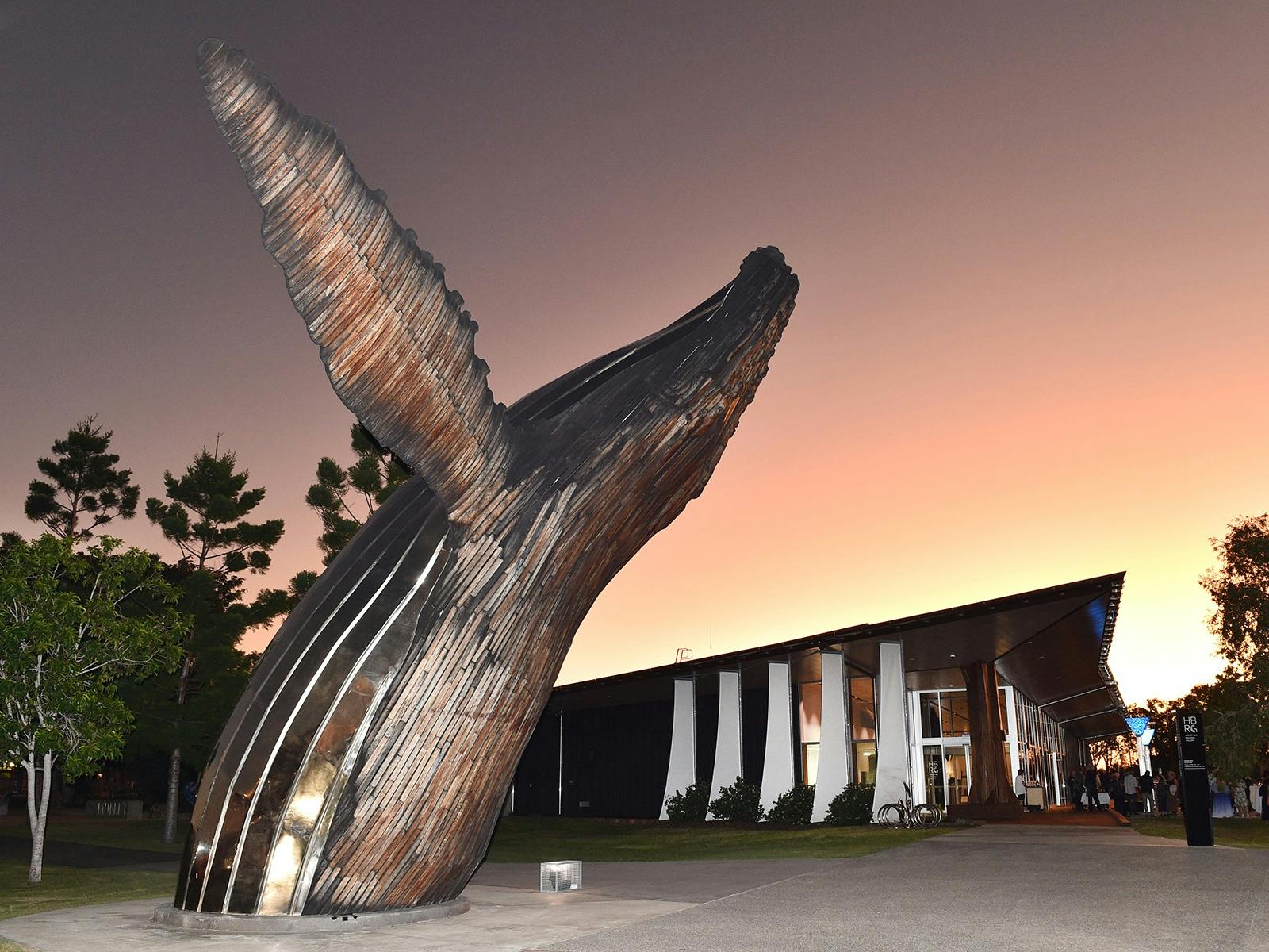 Sunsets behind Hervey Bay Regional Gallery with Nala statue in foreground..