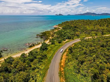 Car driving along the scenic route to Cape Gloucester