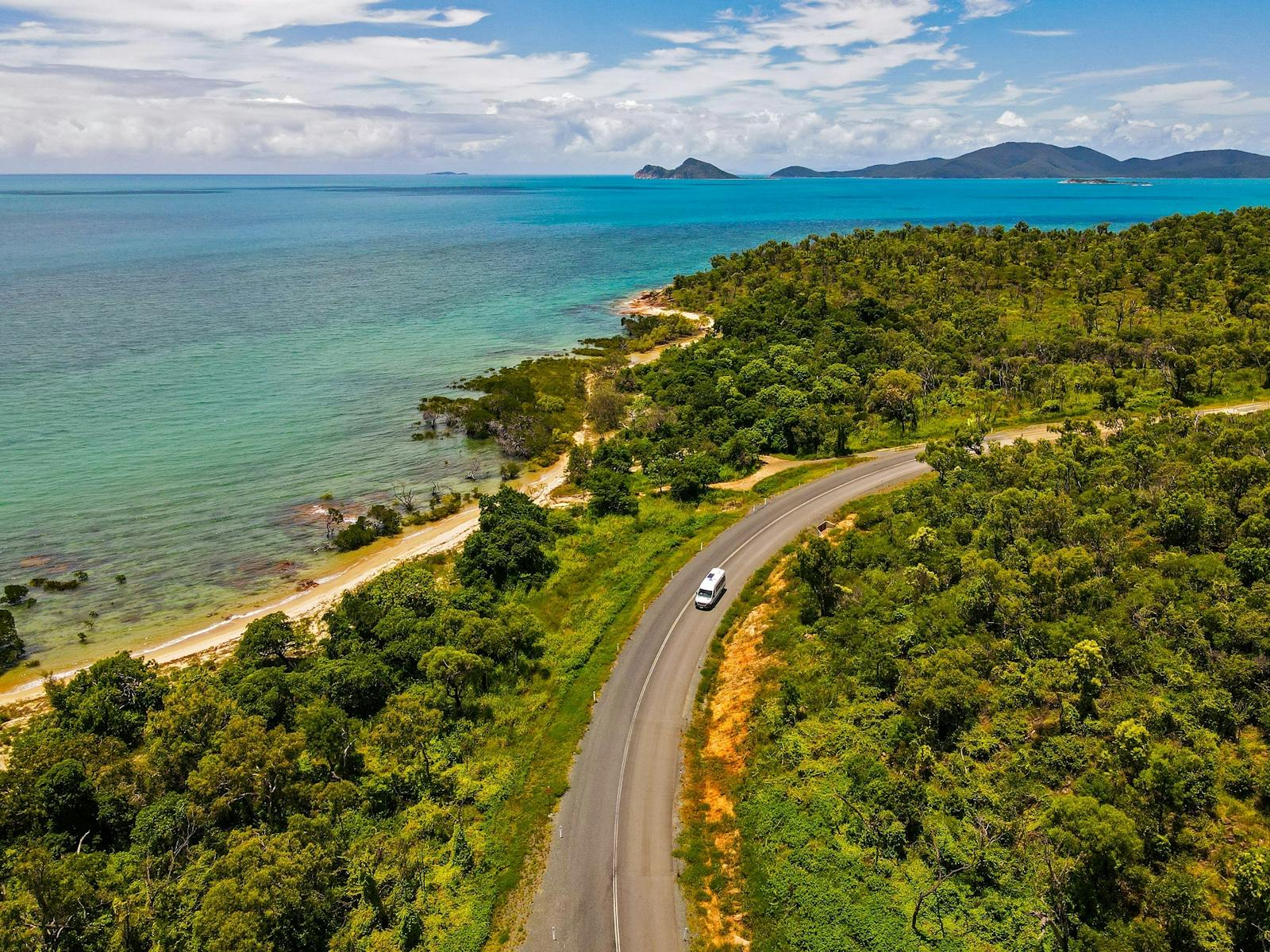 Car driving along the scenic route to Cape Gloucester Car driving along the scenic route to Cape Gloucester
