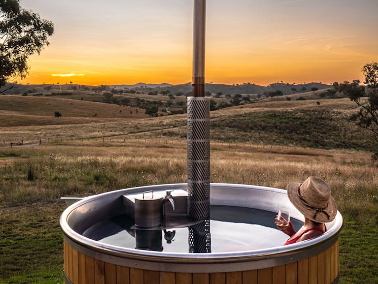 Enjoy watching the sunset in our wood fired hot tub sipping some Mudgee Wine