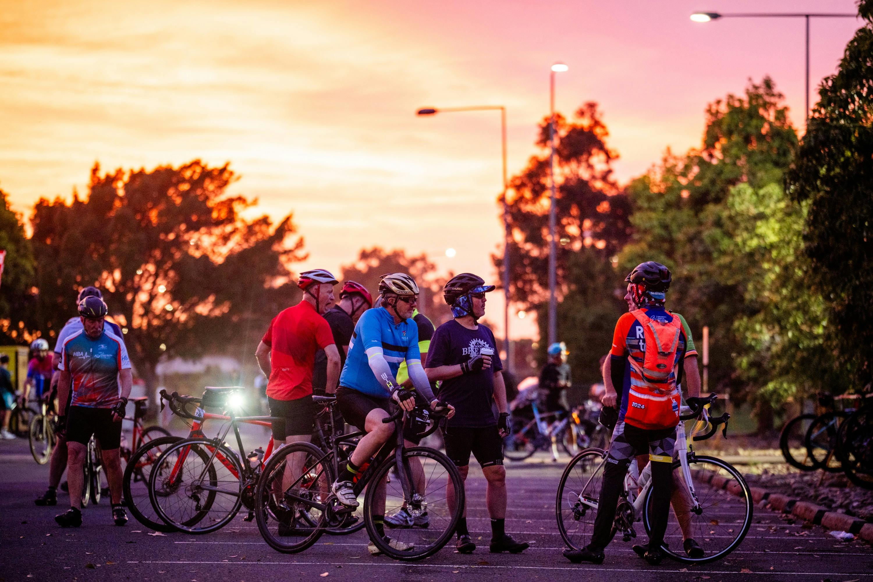 Sunrise in the background. Bike riders relaxing in foreground
