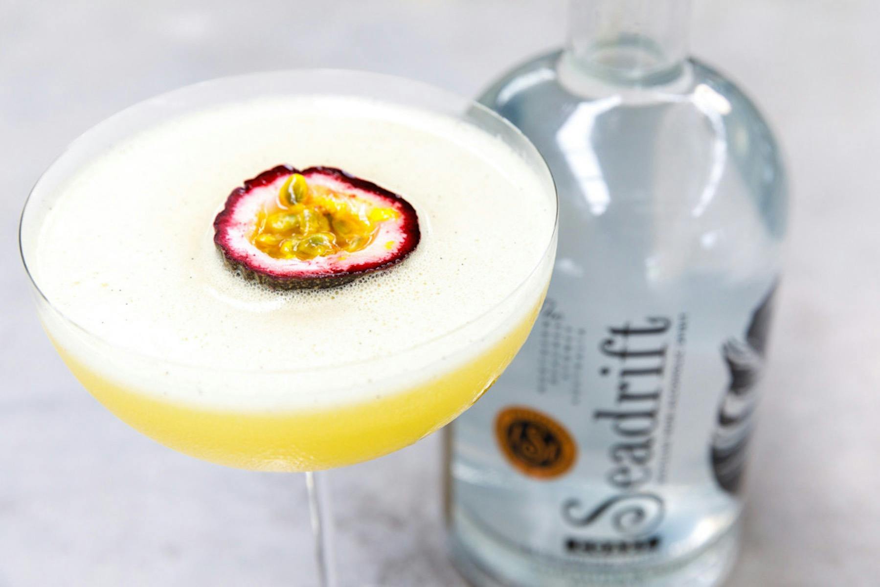 A shot of a Pornstar martini cocktail with half a fresh passionfruit