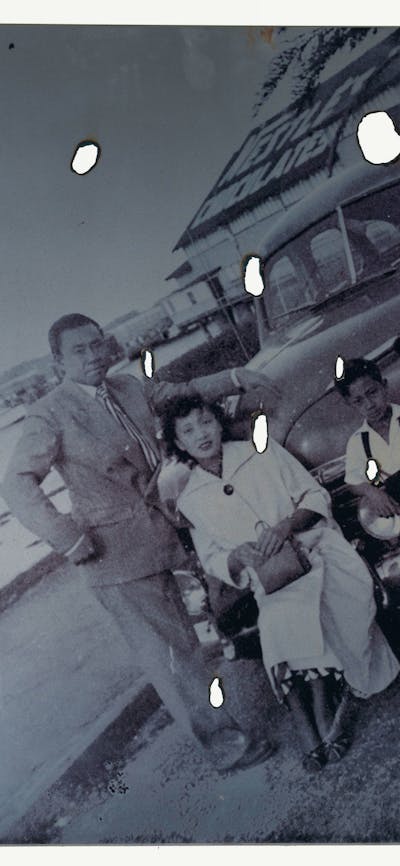Artist Lindy Lee's black and white family photo with burnt holes on the print
