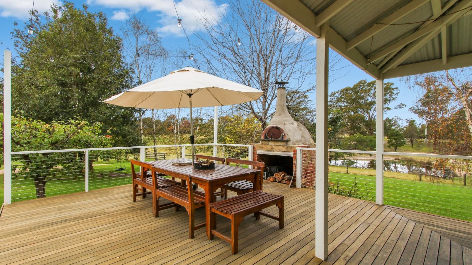 Outdoor deck with pizza oven and dining table