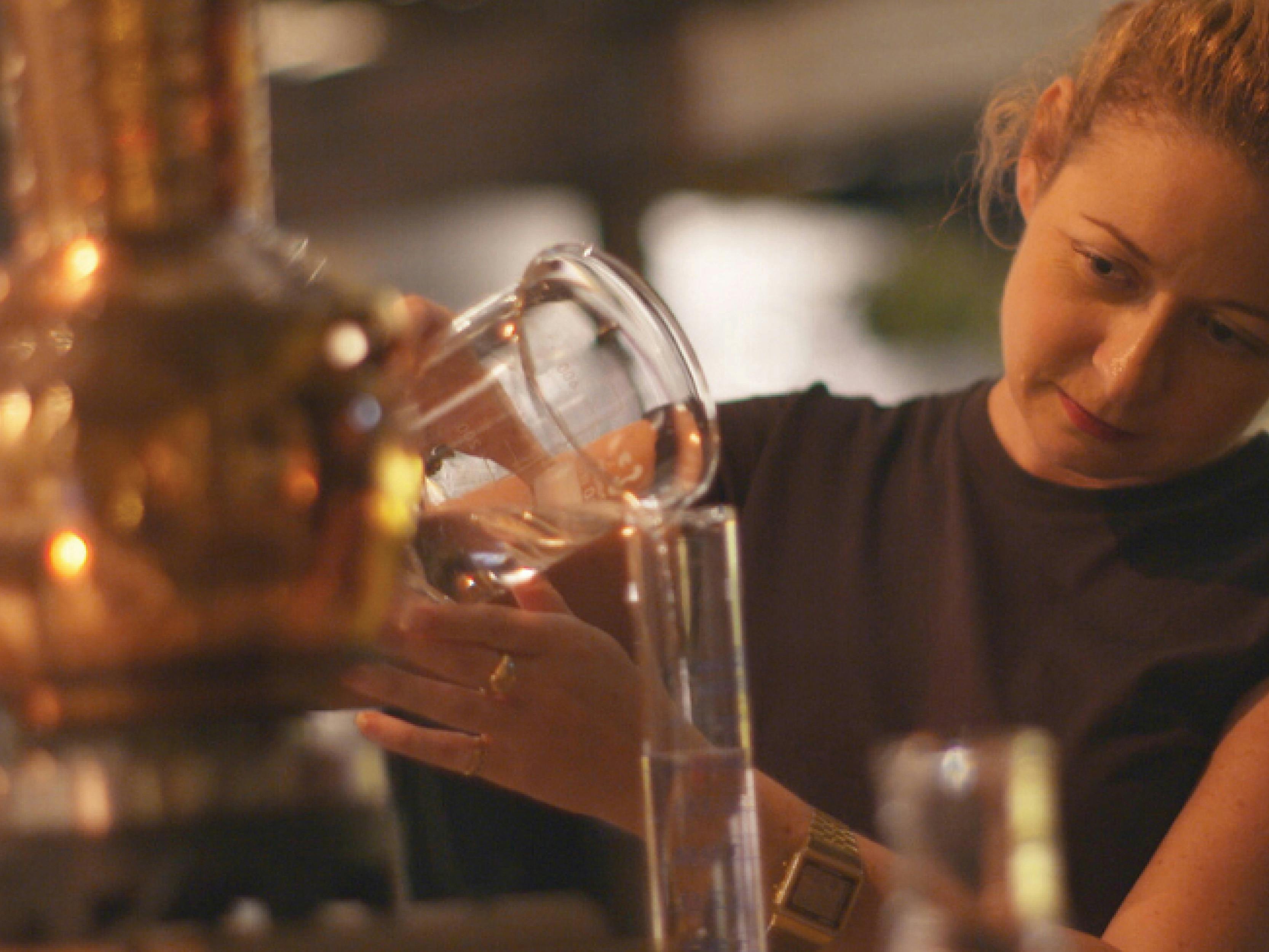 Guest pouring her gin during the make your gin night.