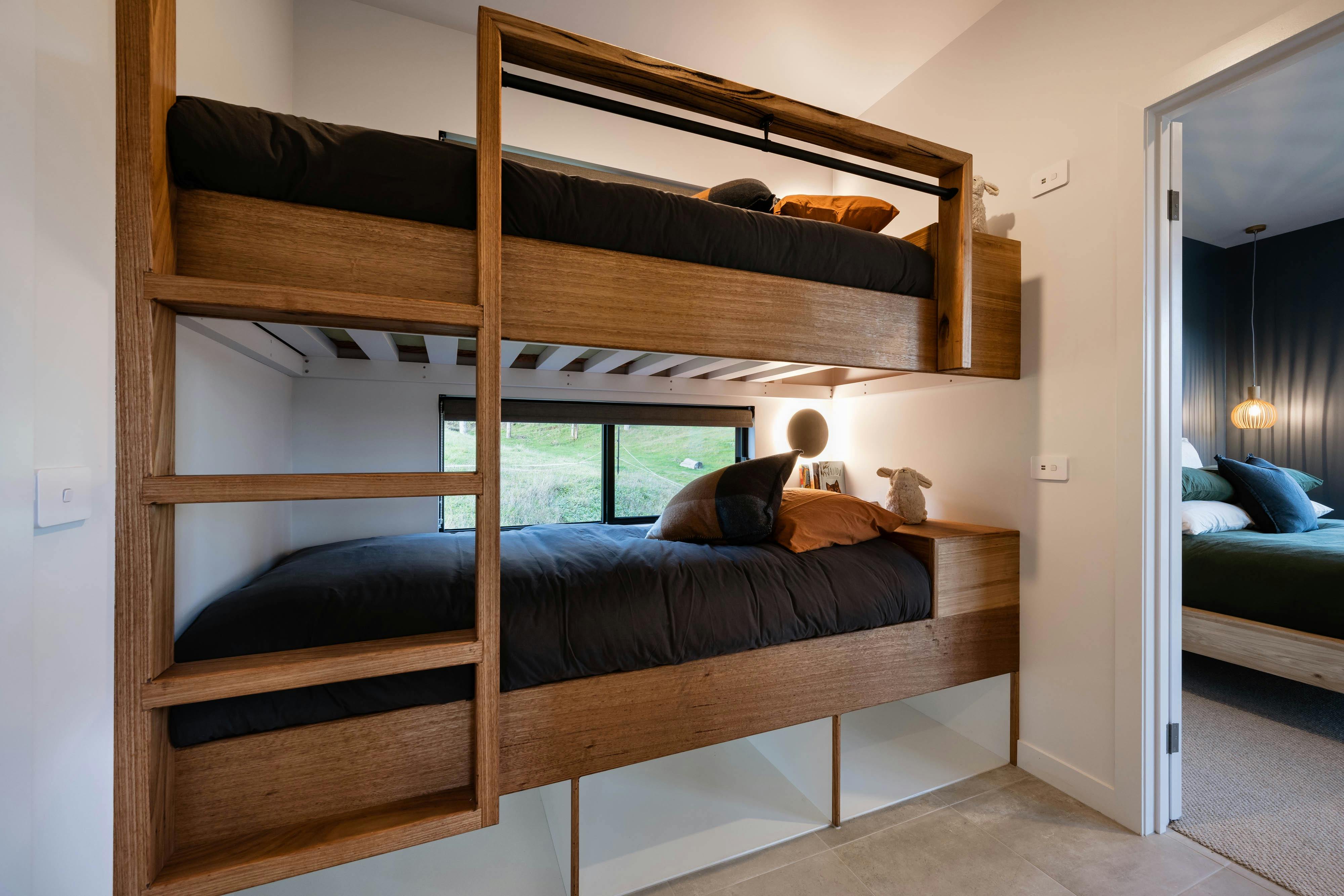 Custom built in bunk beds each with own windows, lighting and USB charger
