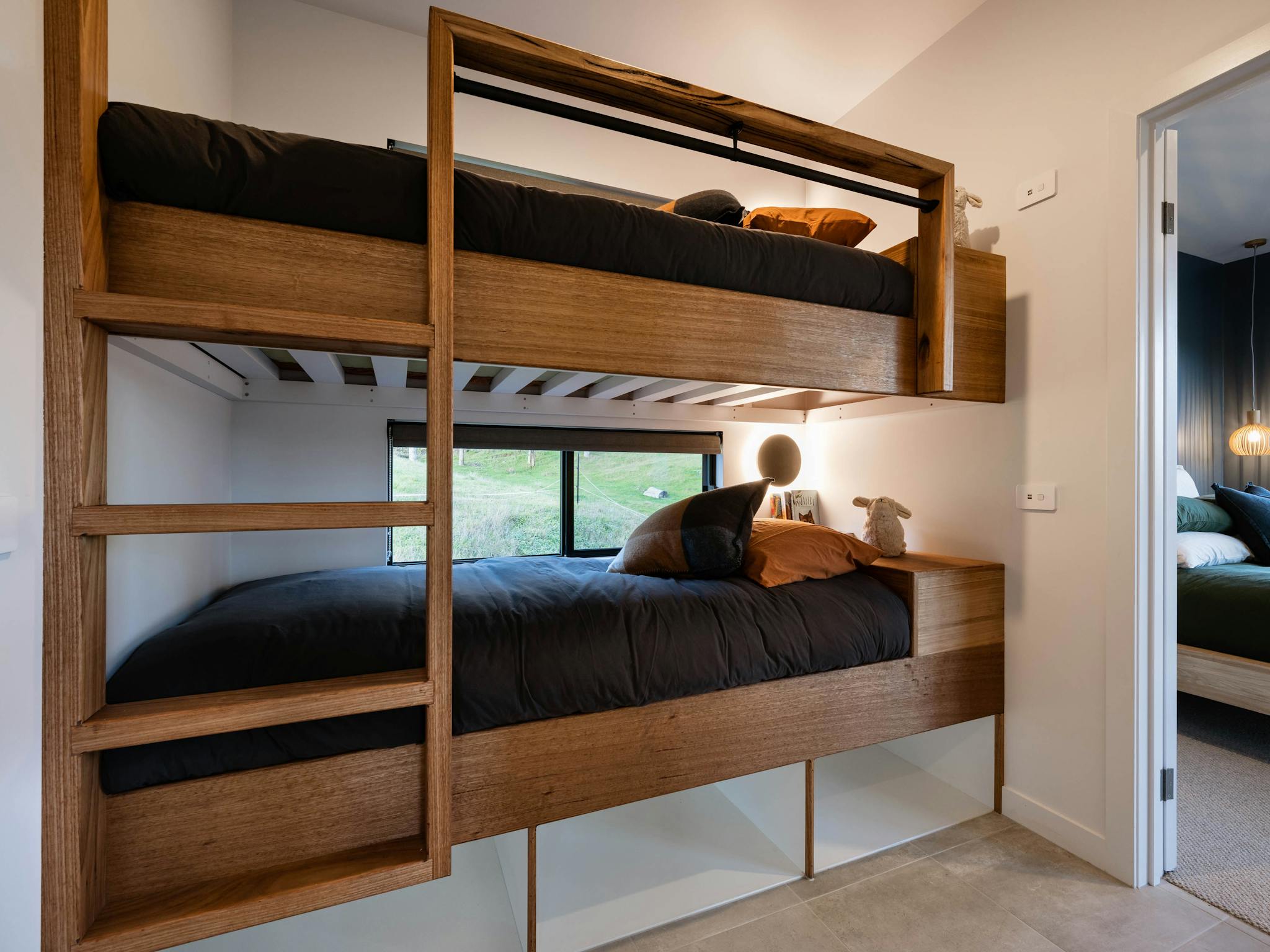 Custom built in bunk beds each with own windows, lighting and USB charger