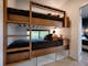 Custom built in bunk beds each with own windows, lighting and USB charger