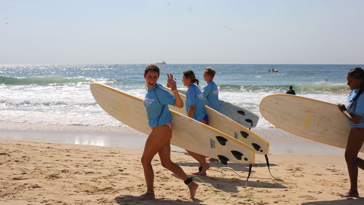 Surfers running to the water