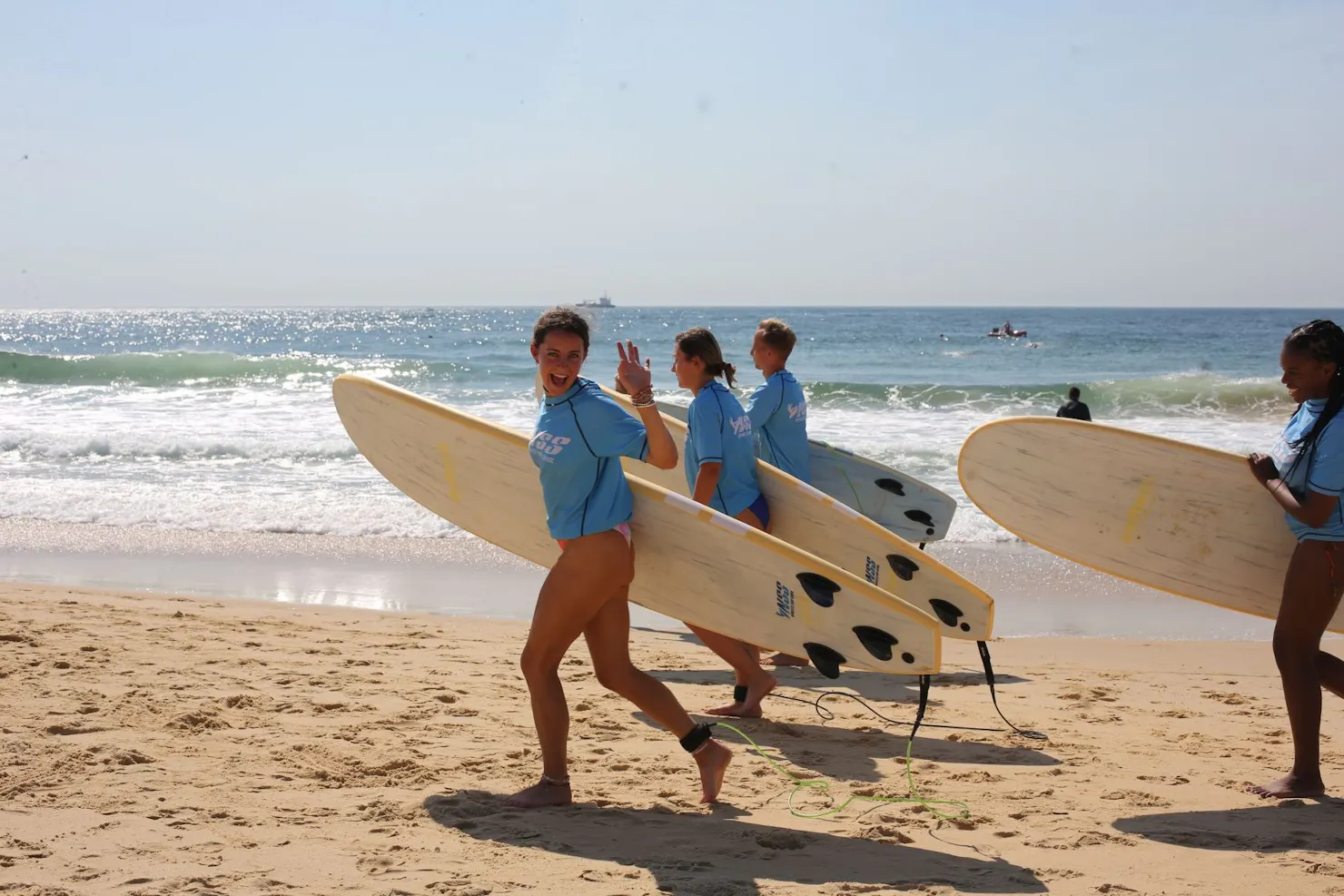 Surfers running to the water