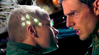 Man looks sternly at young child with nodes attached to the head