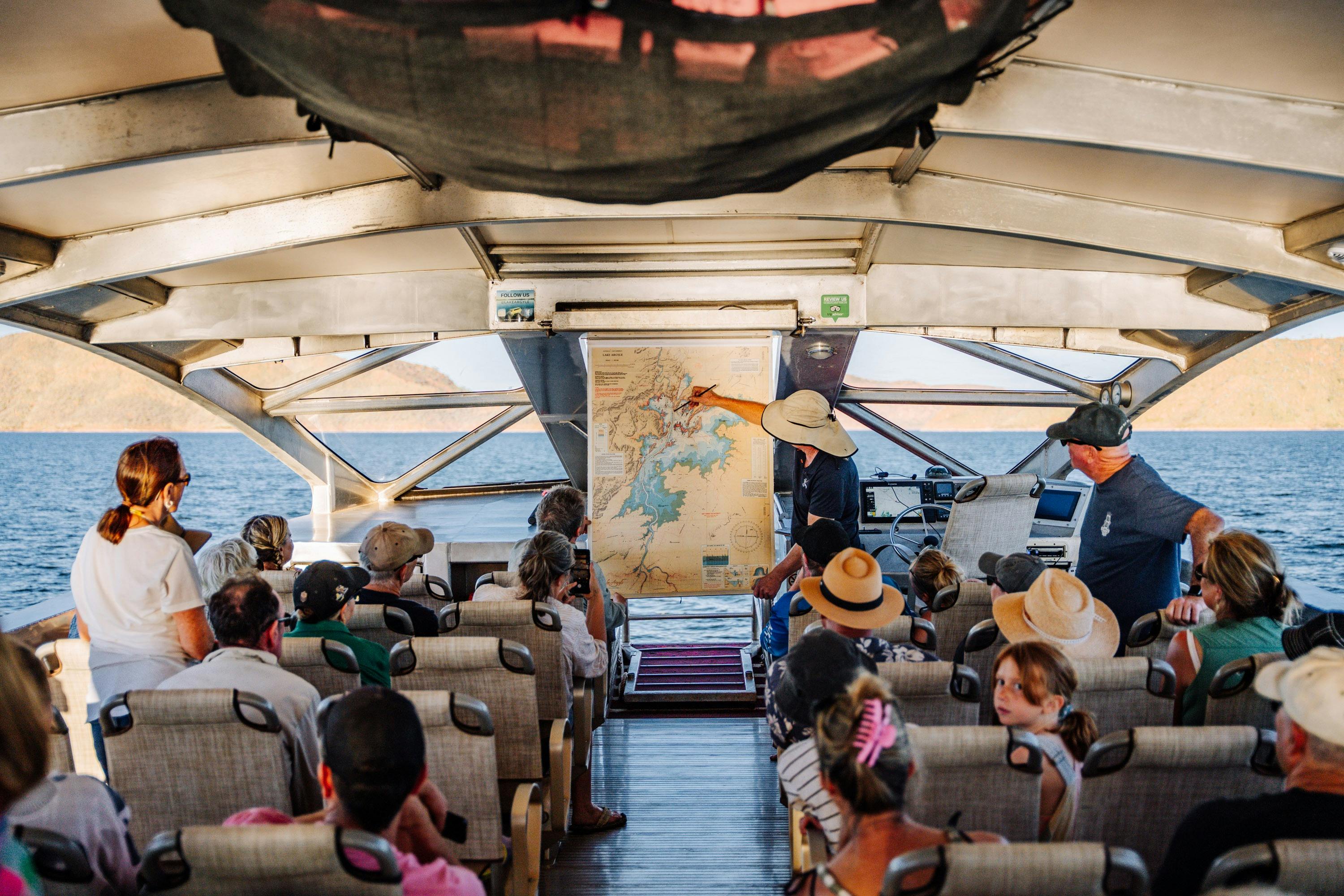 Captain showing Lake Argyle map on board