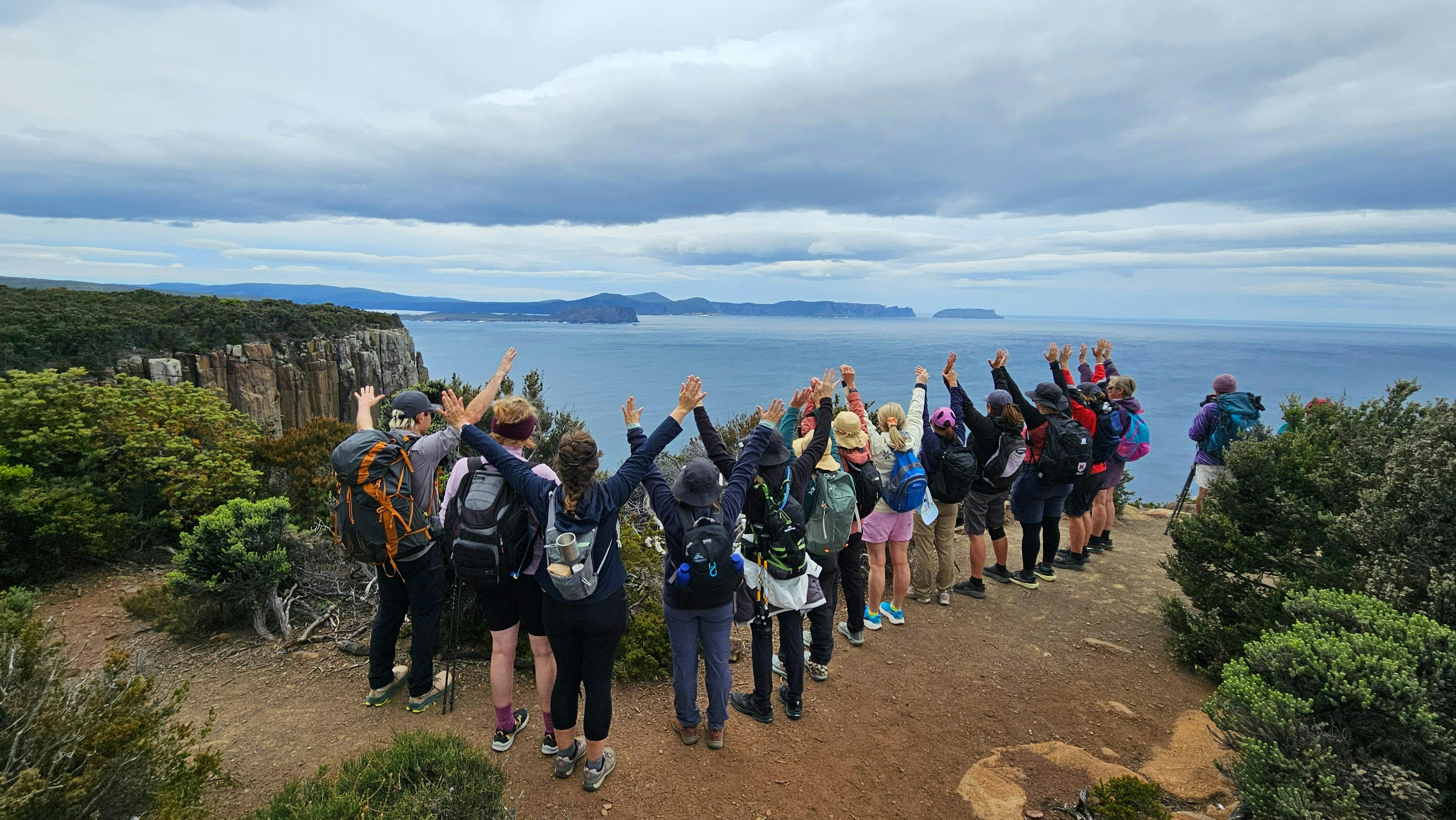 Group celebrating at a lookout on the Three Capes Walk Tasmania guided walking tour