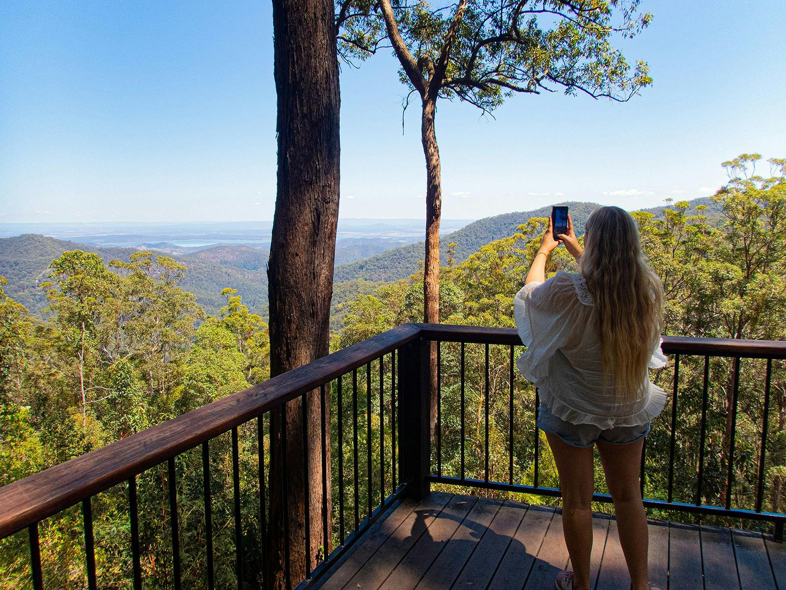 A guest taking an instagram shot at Wivenhoo lookout, Moreton Bay with Brisbane Nature Tours A guest taking an instagram shot at Wivenhoo lookout, Moreton Bay with Brisbane Nature Tours