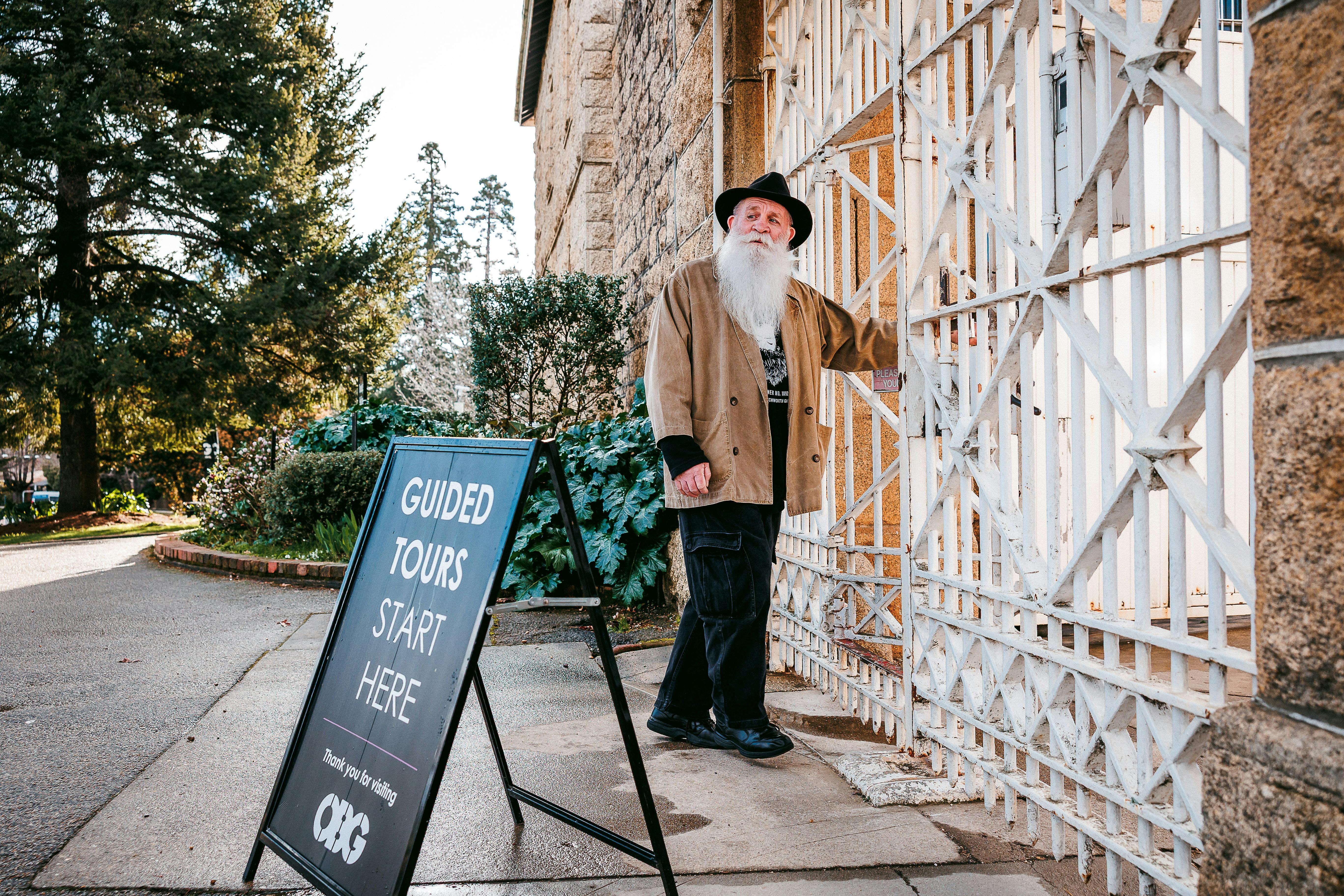 Man standing next to metal entry gates