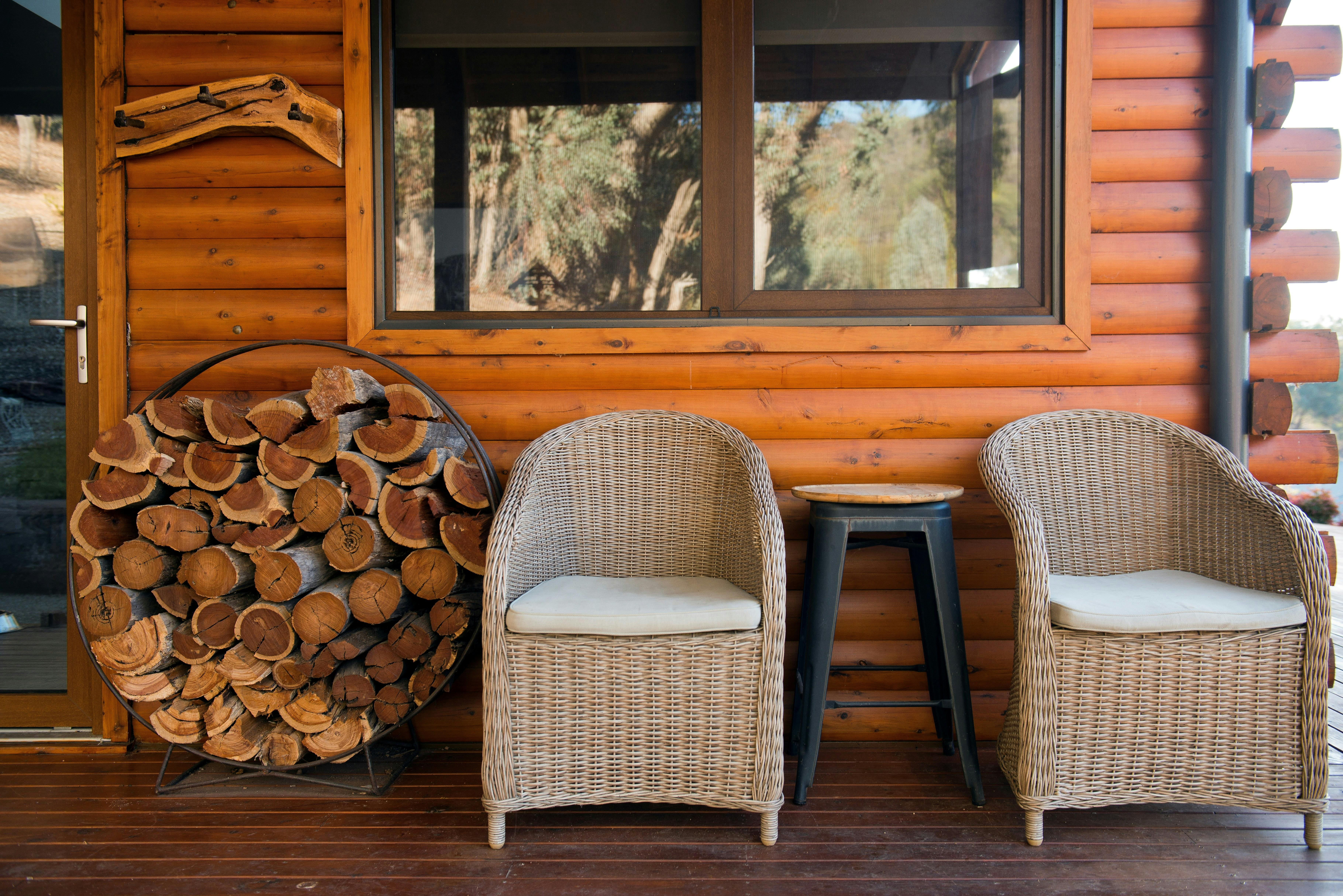 Outside deck with two chairs and firewood