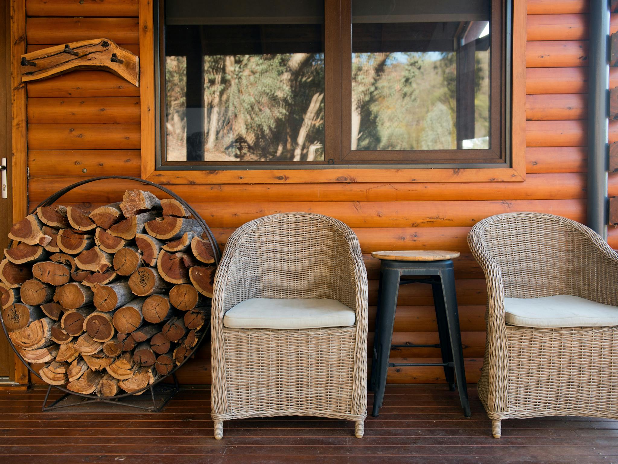 Outside deck with two chairs and firewood