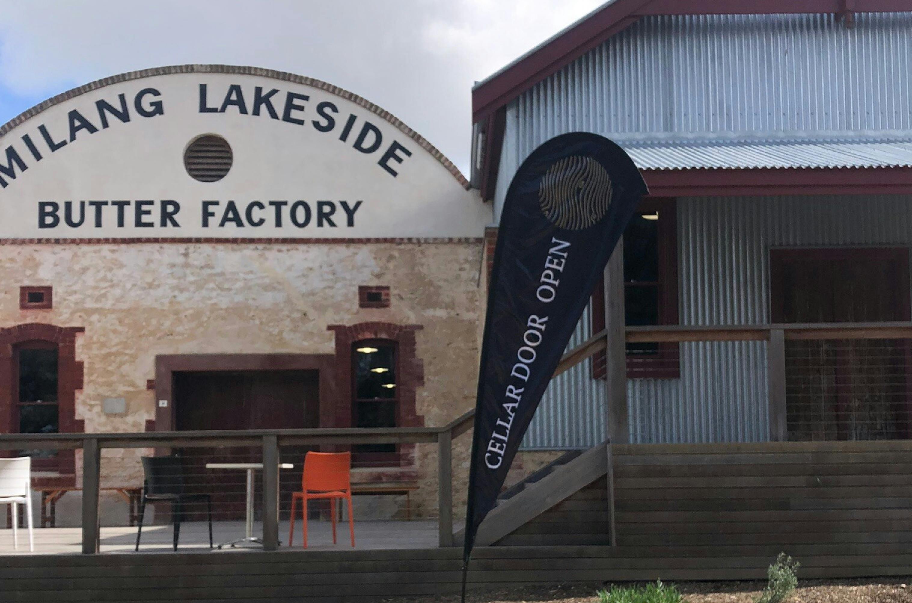 Kanoetree Wines Cellar Door with a black cellar door open flag and chairs and tables ready for enjoy