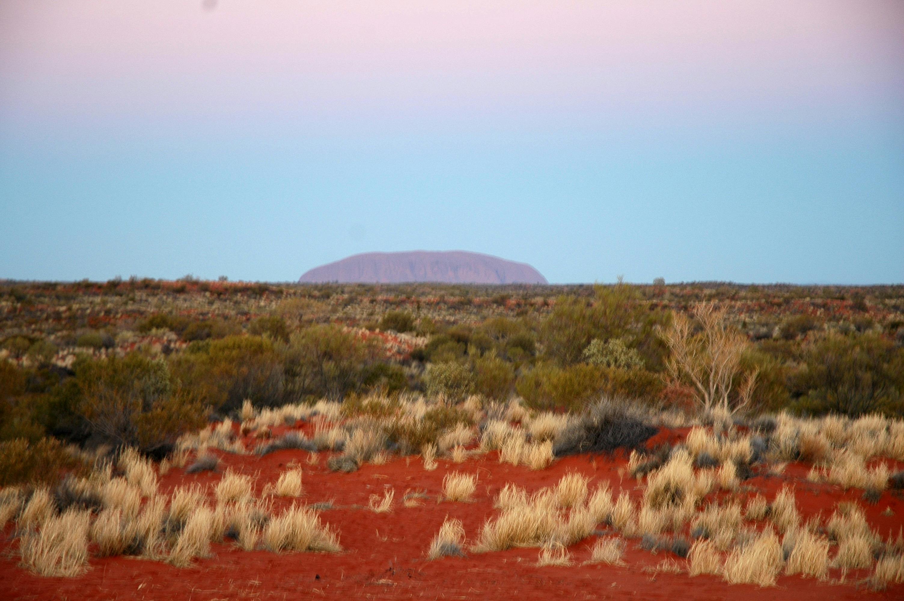Uluru from a distance doesn't get much better! Red sand too!