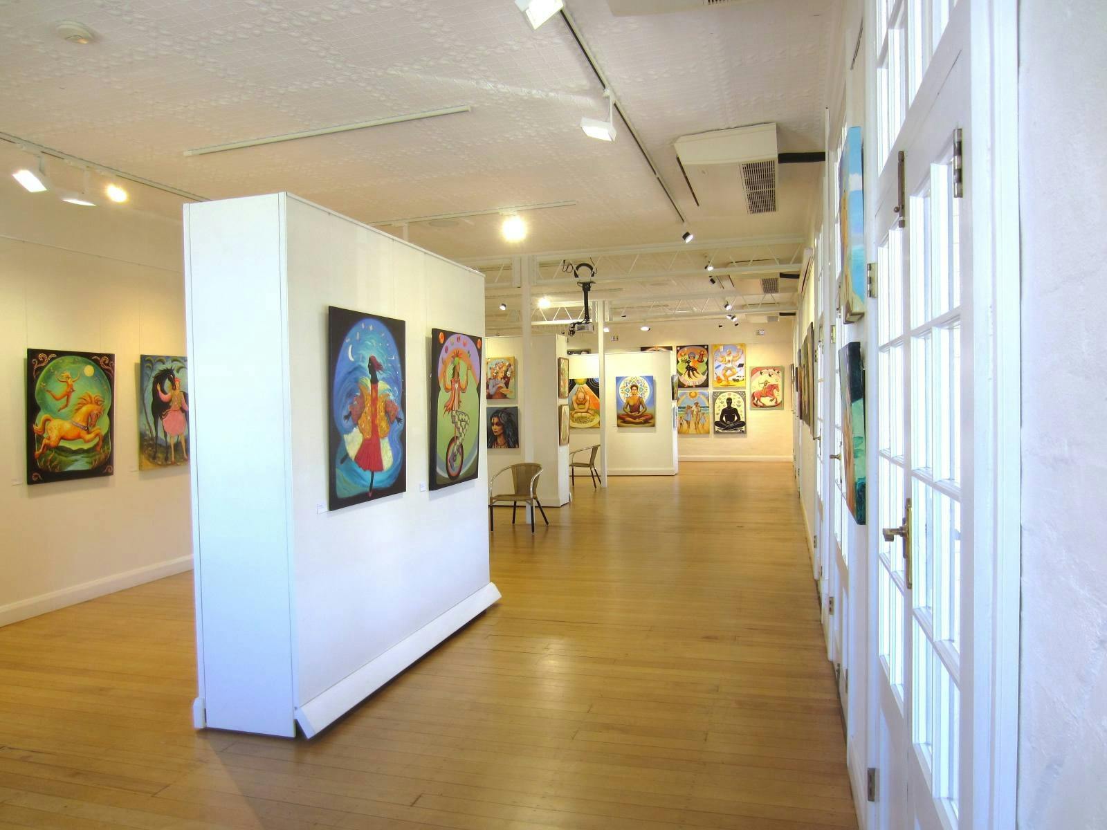 Large colourful paintings on walls throughout gallery space.