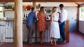 A group of four people enjoy a tasting inside Ashton Hills' rustic cellar door
