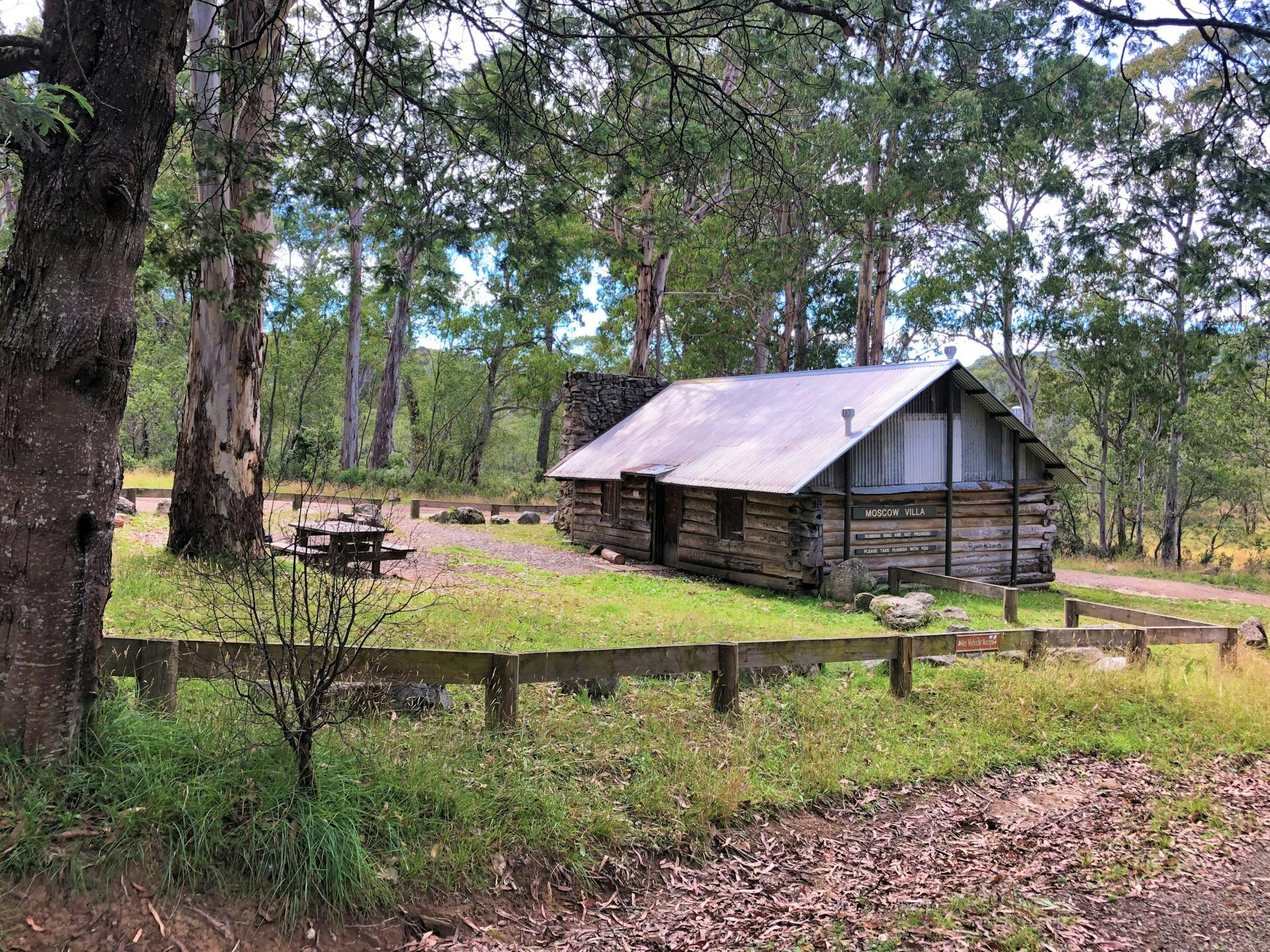 A wooden hut surrounded by forest