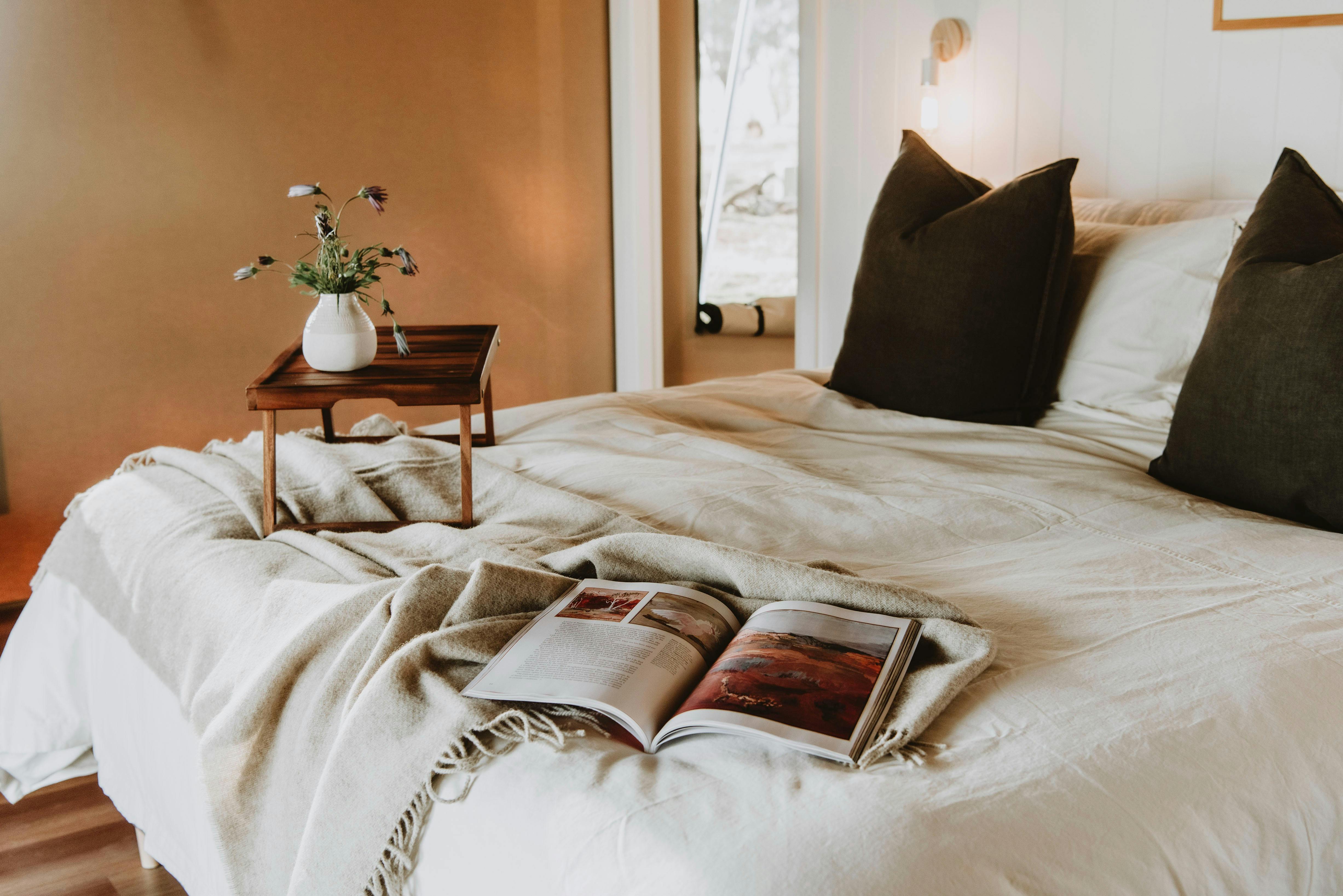 Relax in comfort, plush cushions and magazines on luxurious king bed.