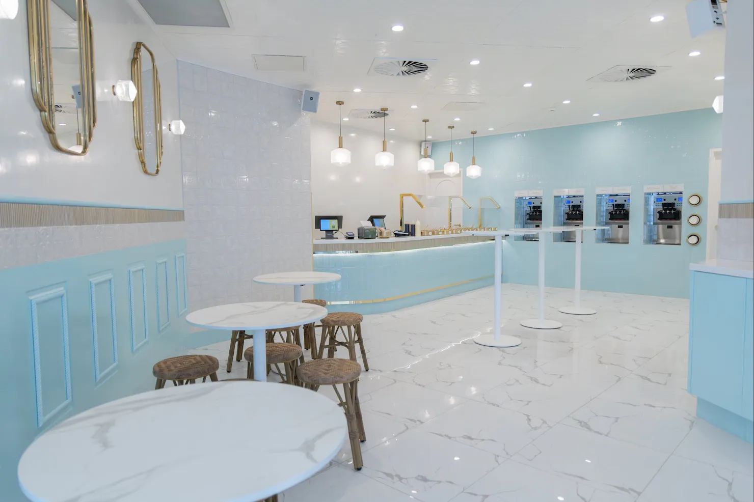 Interior of LUMA Gelato with self-serve gelato machines, seating and blue boutique design