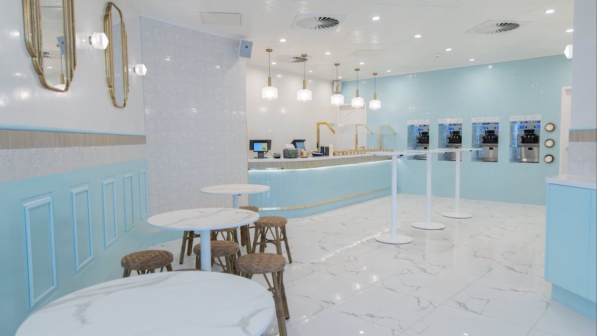 Interior of LUMA Gelato with self-serve gelato machines, seating and blue boutique design