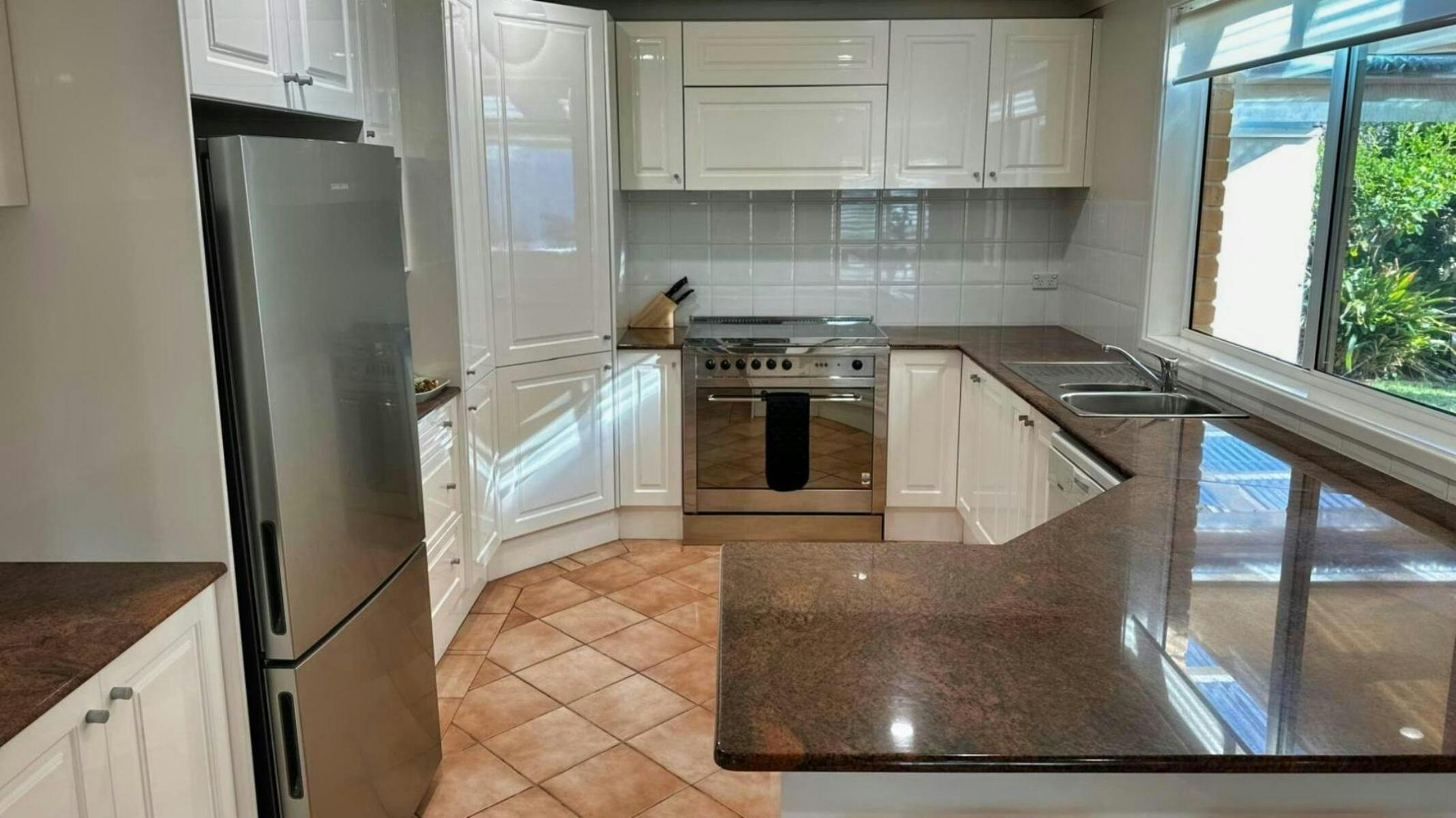 Kitchen with gas stovetop and electric oven