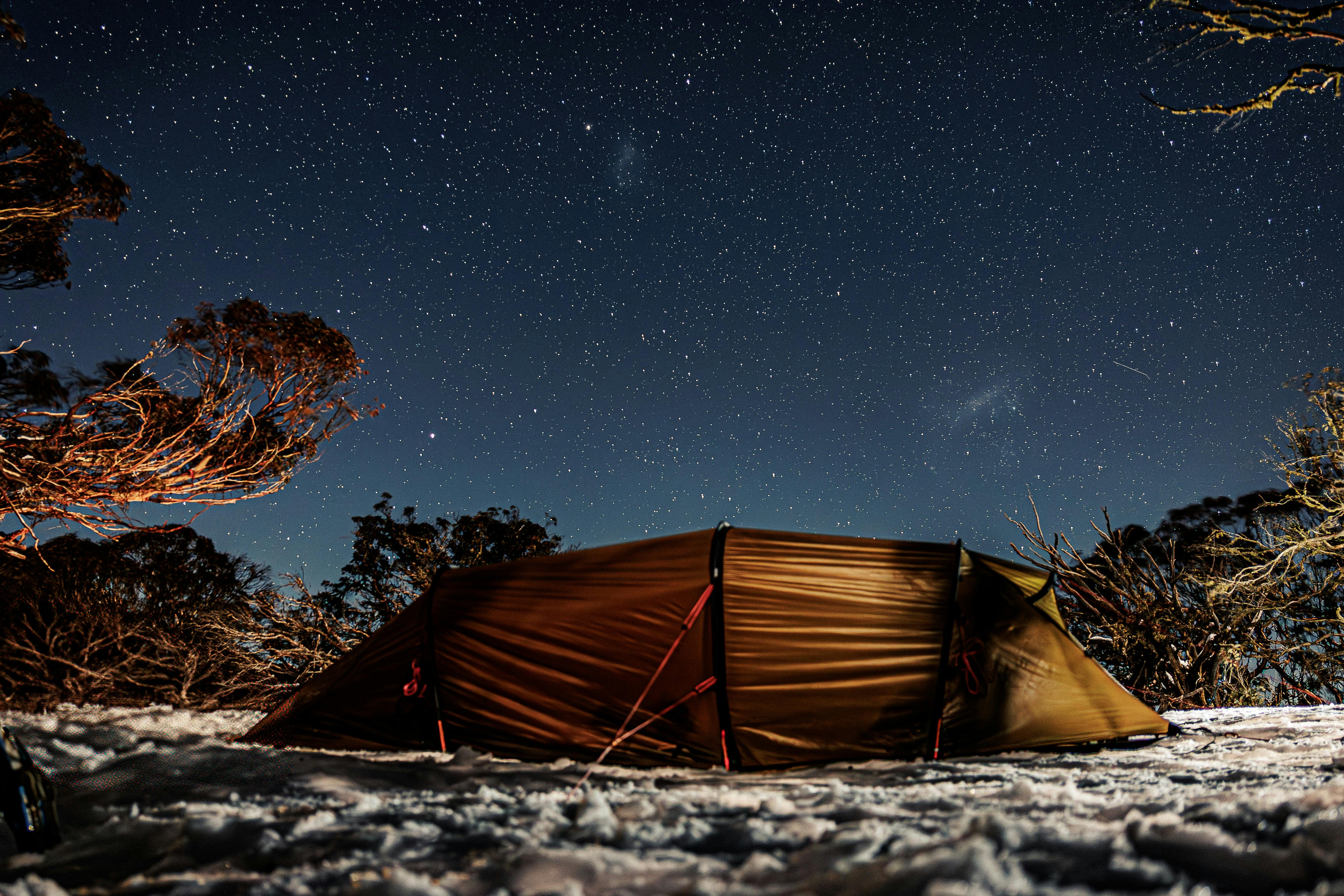 Snow camping under a winter star studded sky