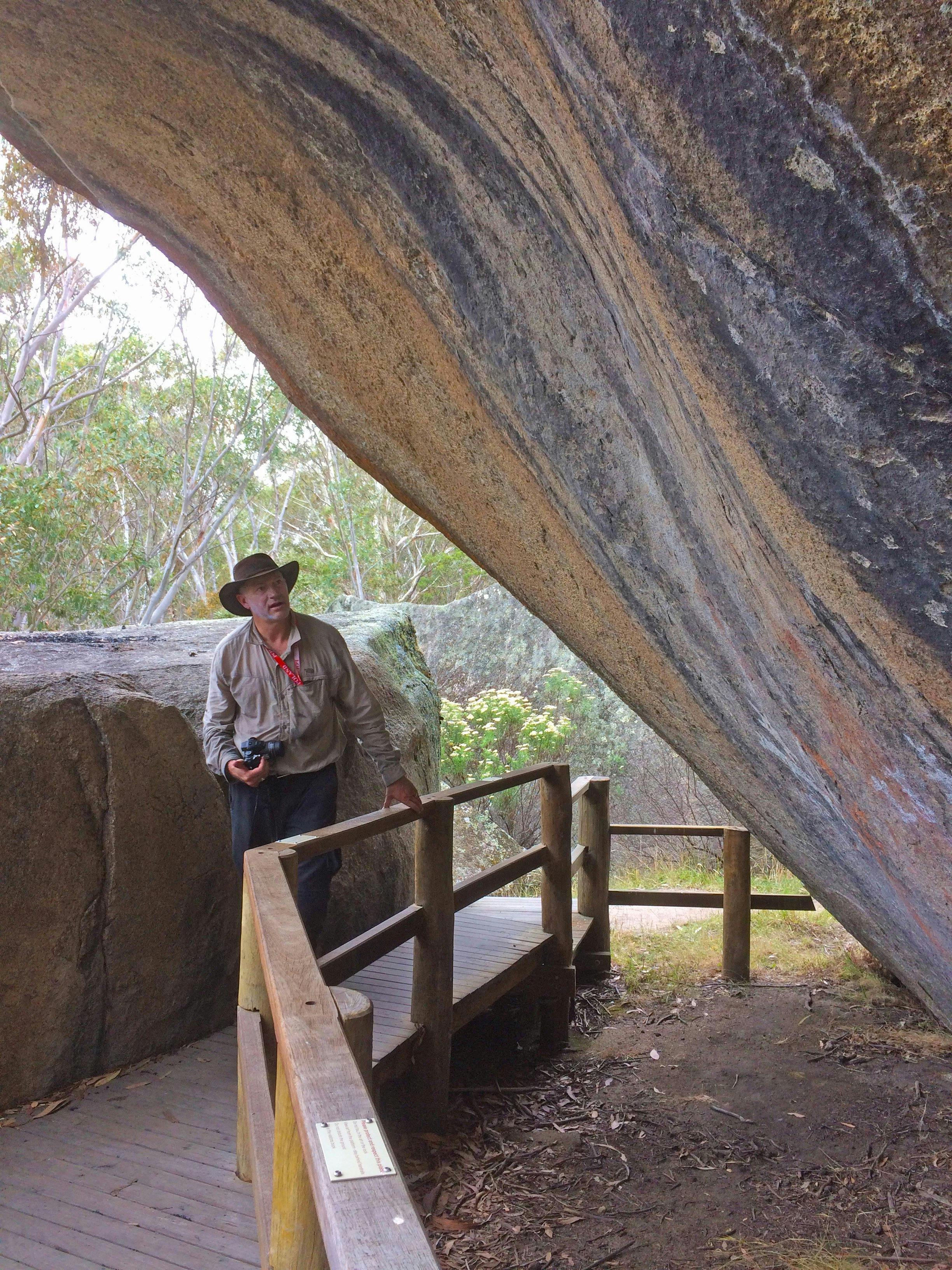 Man with a camera at Yankee Hat Aboriginal Rock Art site