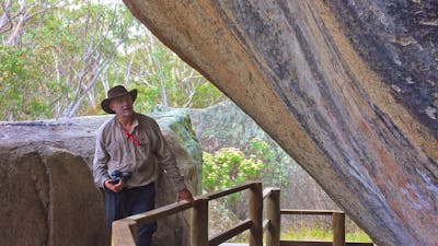Man with a camera at Yankee Hat Aboriginal Rock Art site