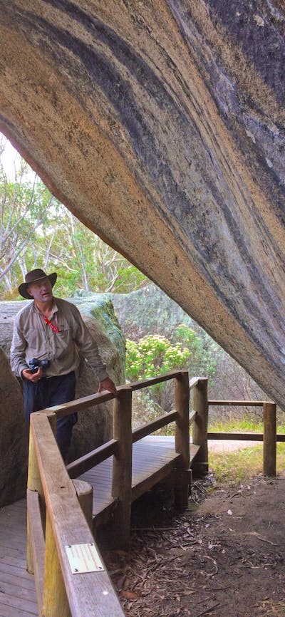 Man with a camera at Yankee Hat Aboriginal Rock Art site