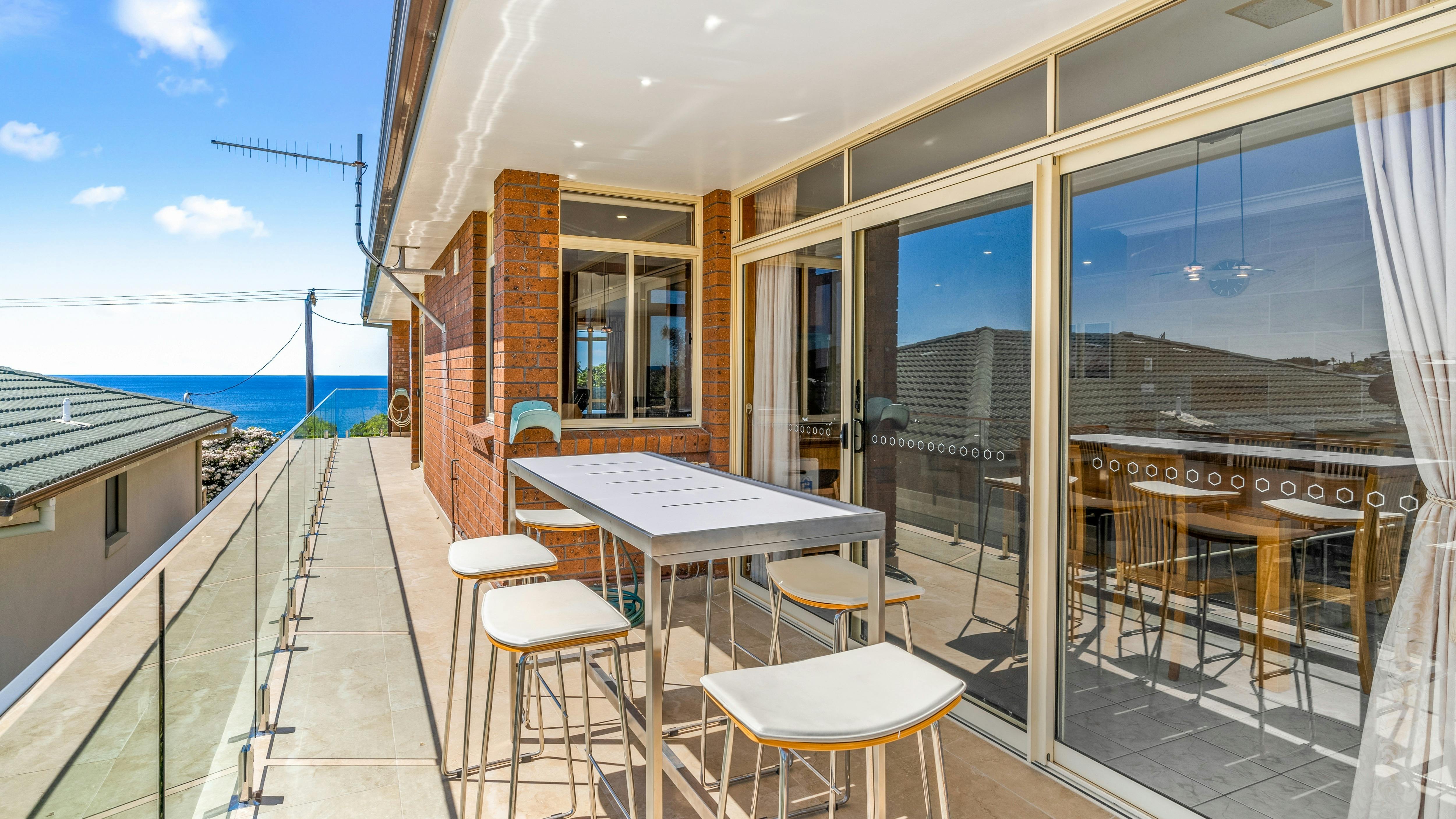 Balcony with ocean views and high bar setting