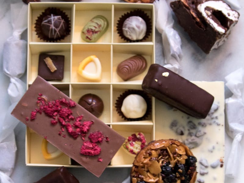 Variety of chocolates, bars and confections arranged on marble Variety of chocolates, bars and confections arranged on marble