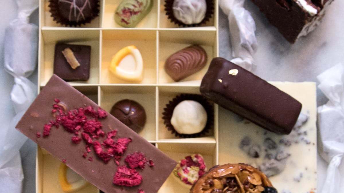 Variety of chocolates, bars and confections arranged on marble