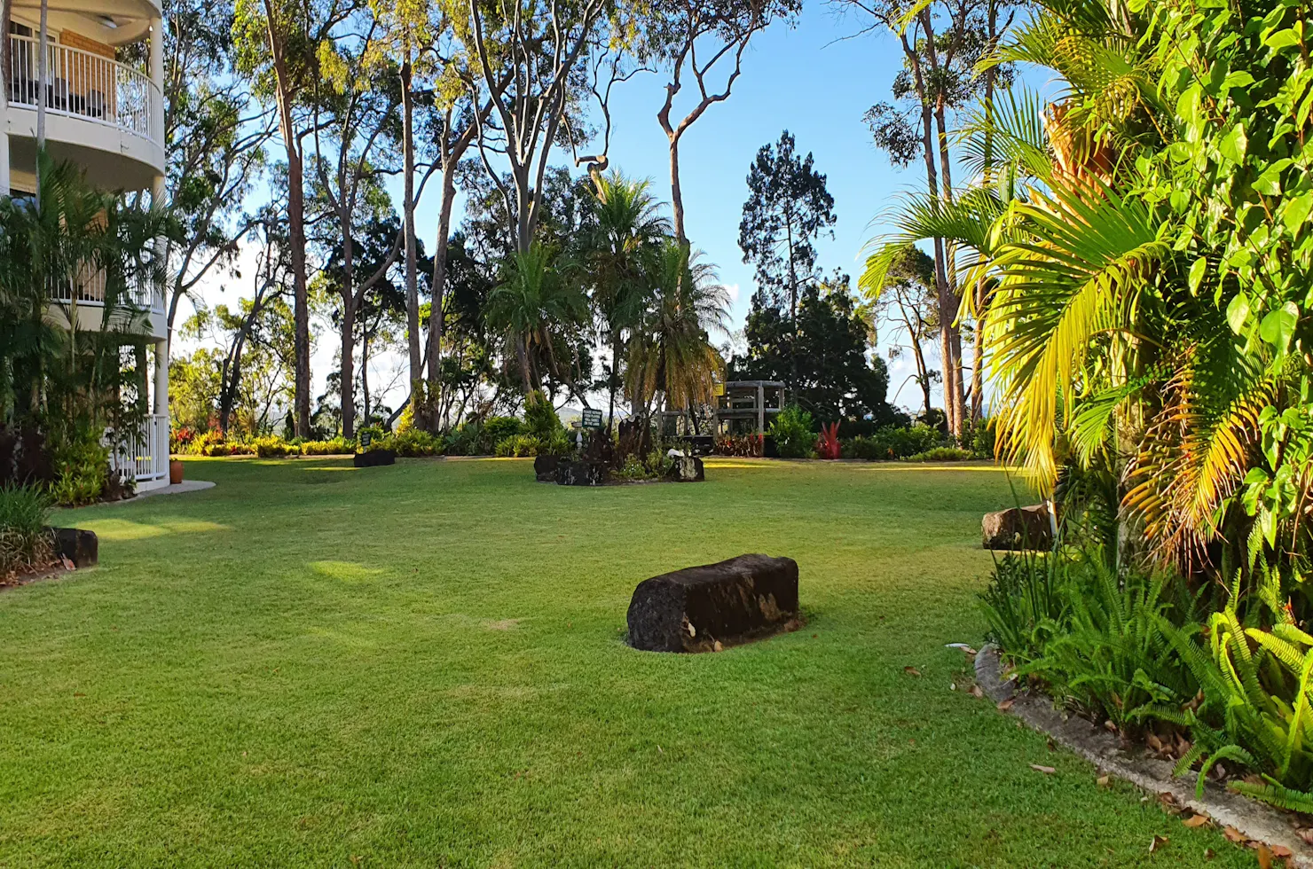 large lawn area which leads to small beach at Macquarie Lodge Noosa