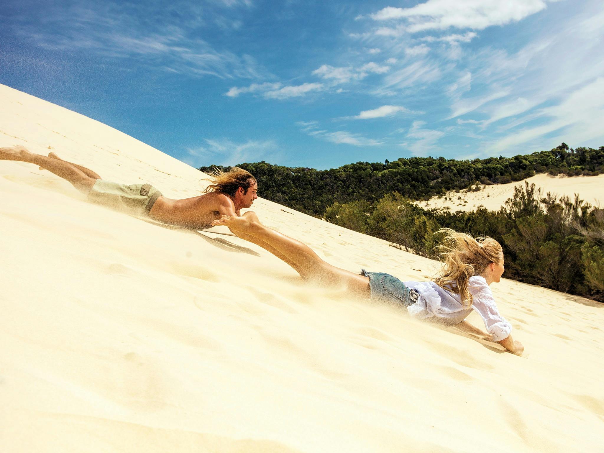 Sand tobogganing on the Desert Safari Tour