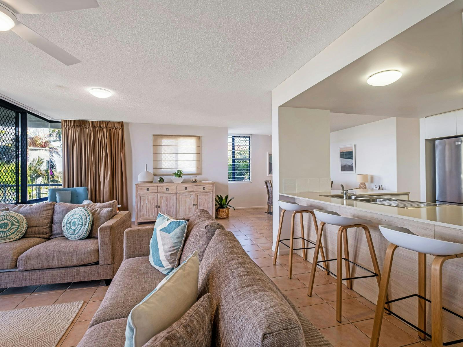 Open plan living, kitchen and dining area with balcony access