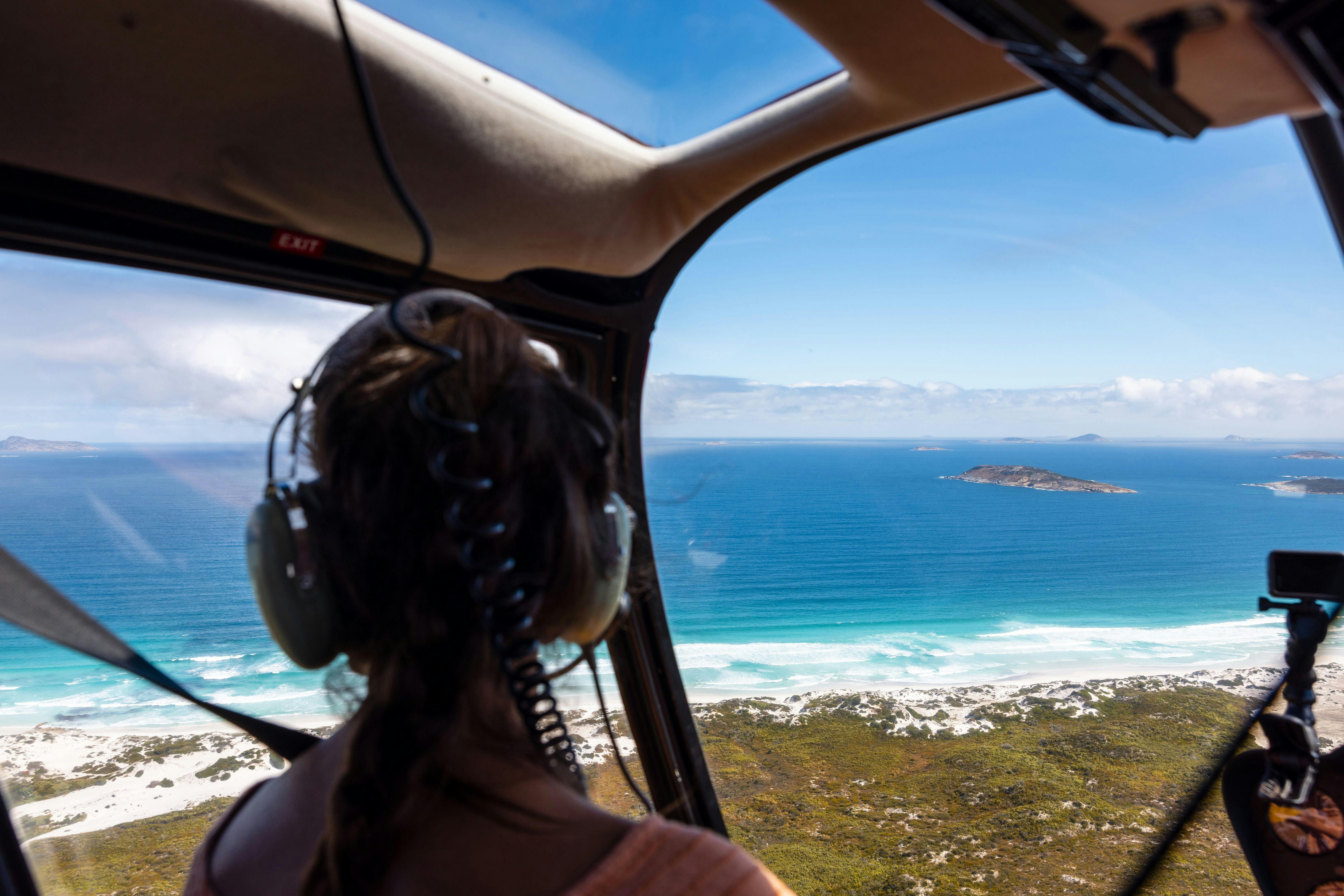 POV from inside helicopter flying over the Esperance coastline