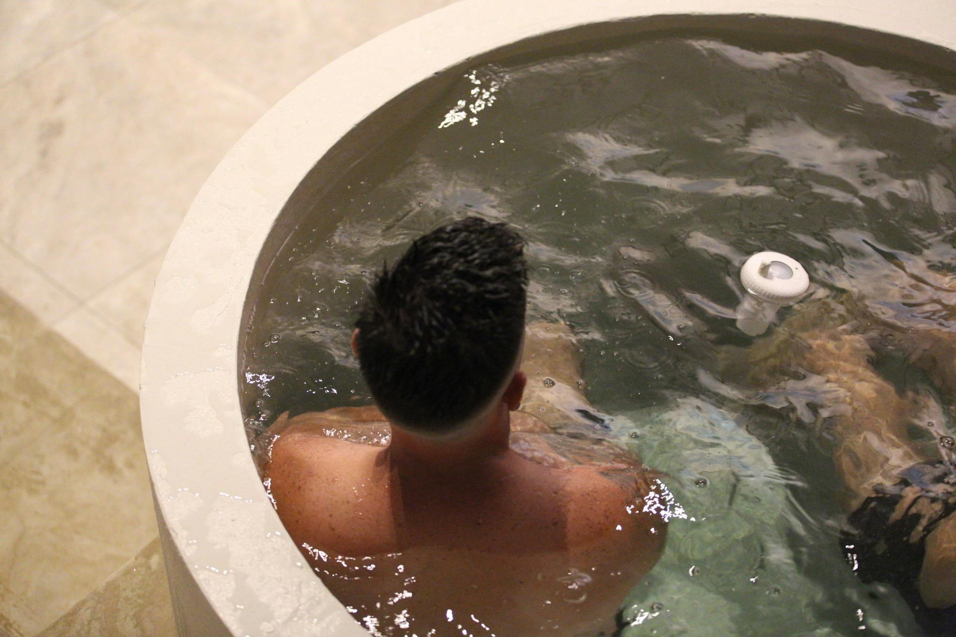 Man sitting in an ice bath