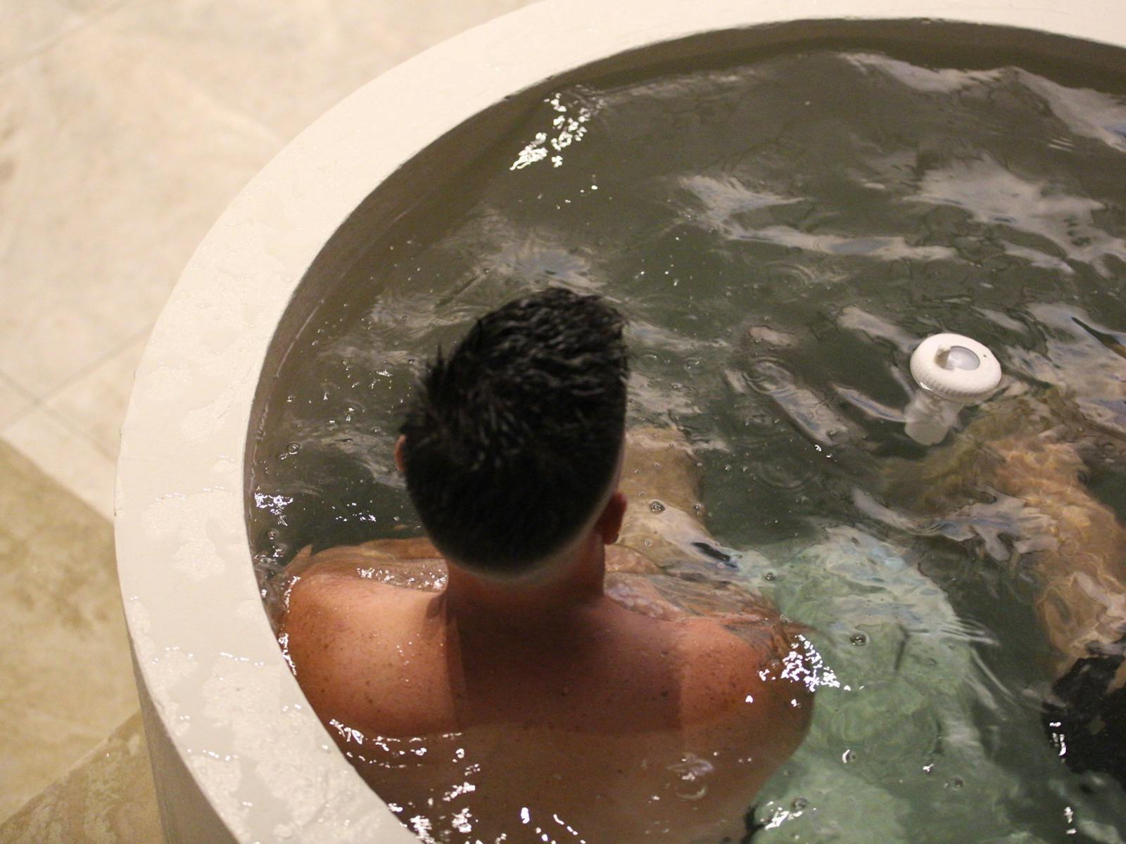 Man sitting in an ice bath