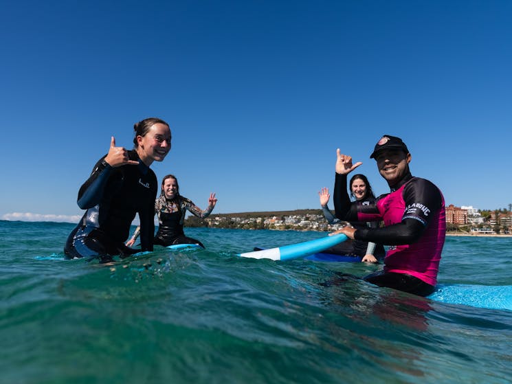 Group of 3 surfing with Manly Surf School Coach
