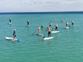 International exchange students experience SUP for the first time, at Southend Jetty